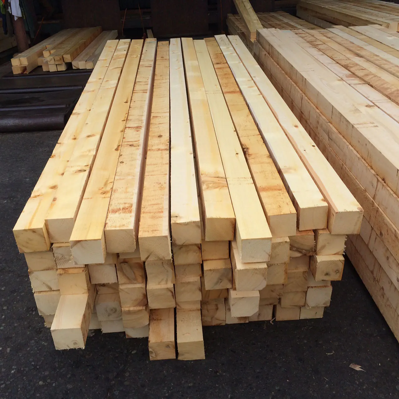 Stack of pale Alaskan yellow cedar boards in a sawmill