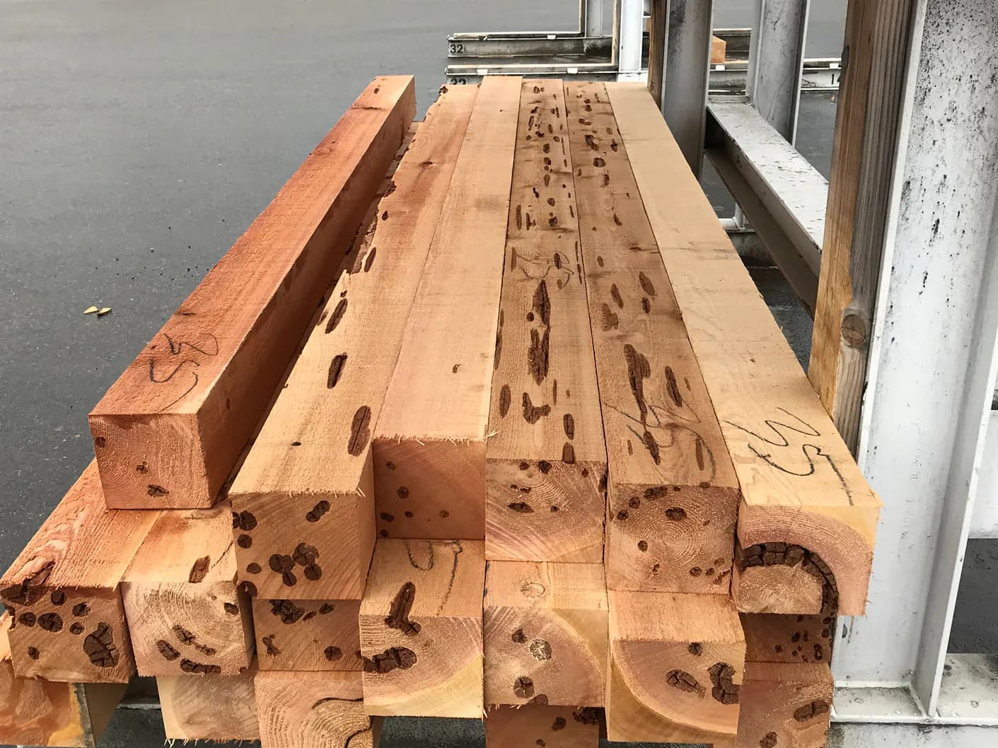 Stack of incense cedar timbers with visible knots and character