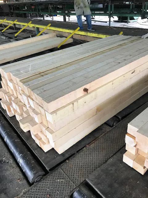 Port Orford cedar boards stacked on a mill sorting line
